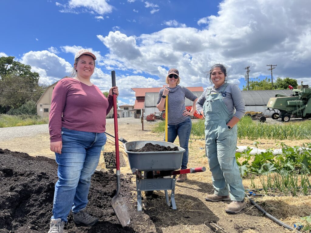 California Farm Academy students shovel compost at the farm