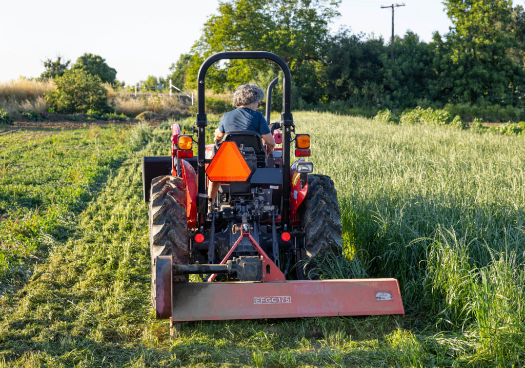 California Farm Academy student practicing mowing with a tractor in our Tractor Training course